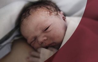 Newborn baby at the breast